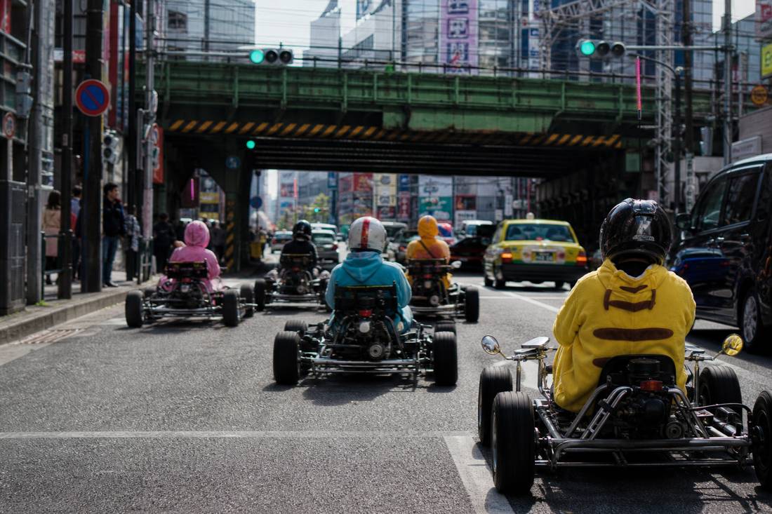 Go-kart convoy passing under the Akihabara rail bridge