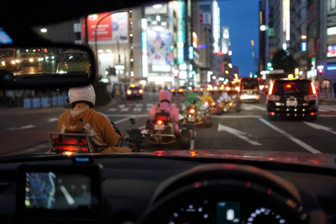 Driver's view down an Akihabara street from a go-kart
