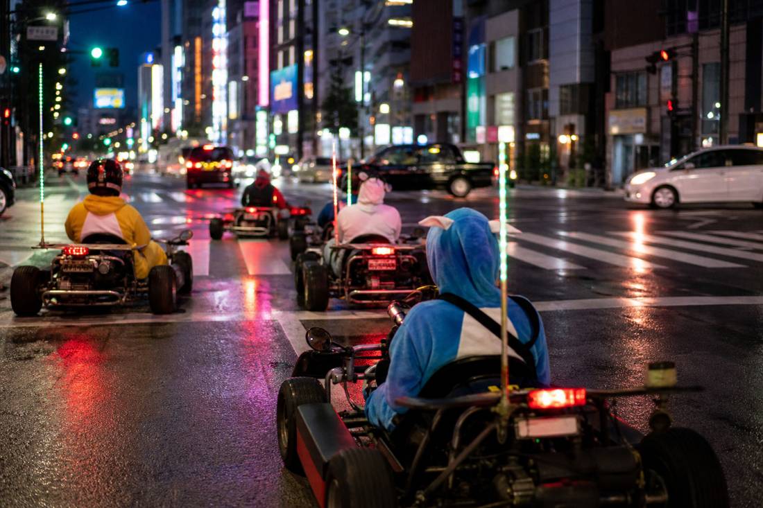 A neon Tokyo street at night with go-karts