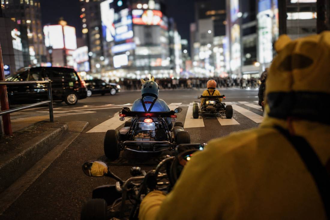 Night go-kart view of the glowing Shibuya Scramble