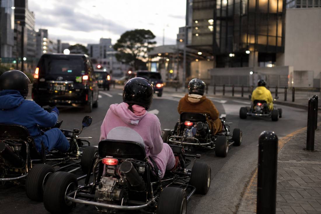 Go-karts returning to the garage at dusk in Tokyo