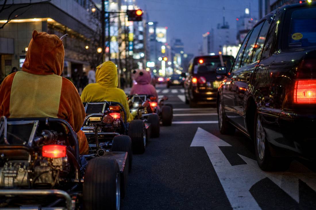 Go-kart convoy stopped in line at a Tokyo red light