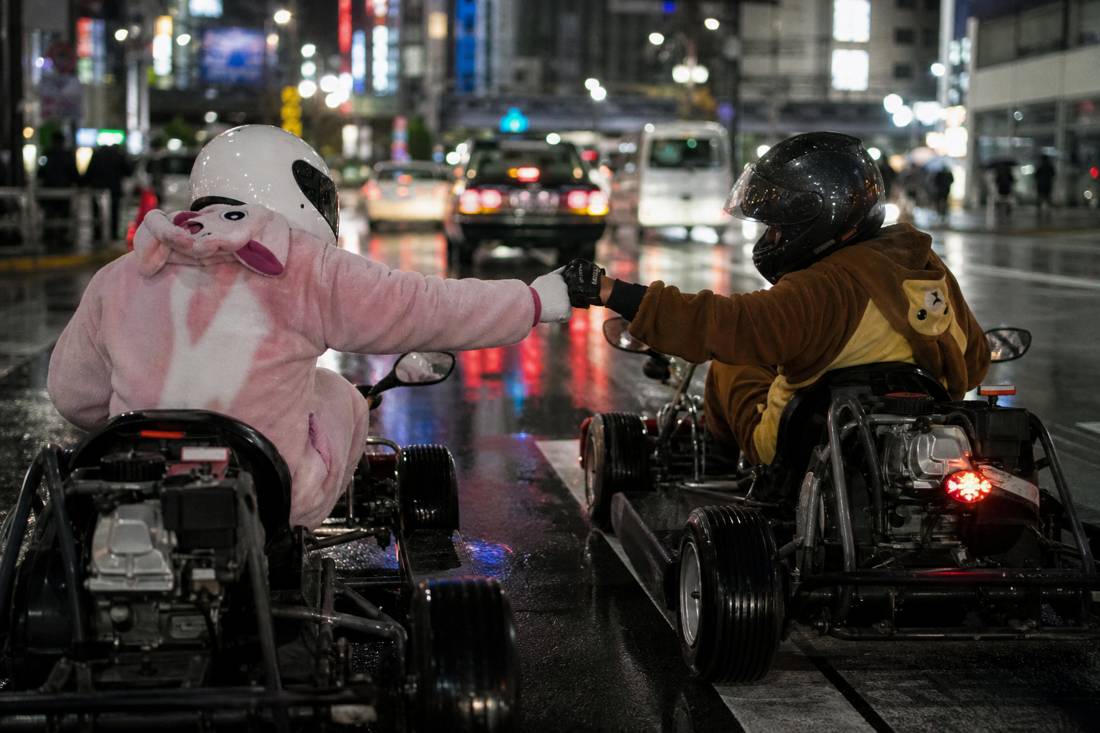 Two go-karts side by side at a Tokyo red light