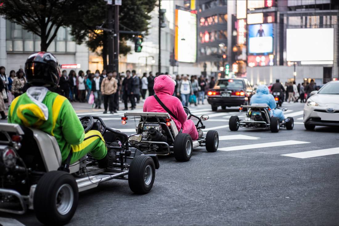 Go-karts crossing the Shibuya Scramble among pedestrians