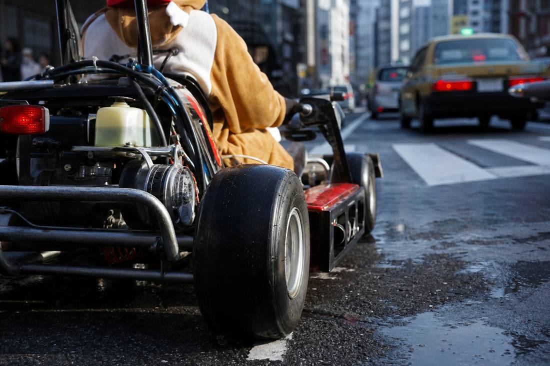 Close view of an unbranded street go-kart frame and wheel