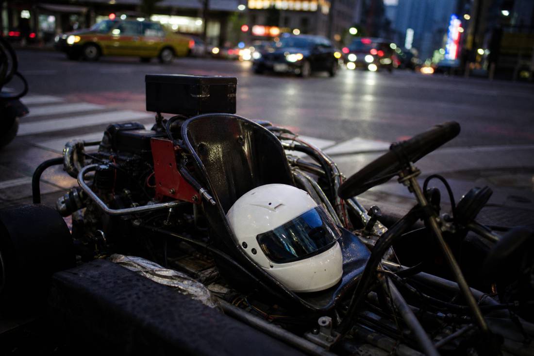 An open go-kart with a helmet resting on the seat