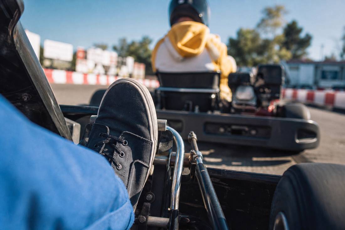 Closed-toe sneakers on street go-kart pedals