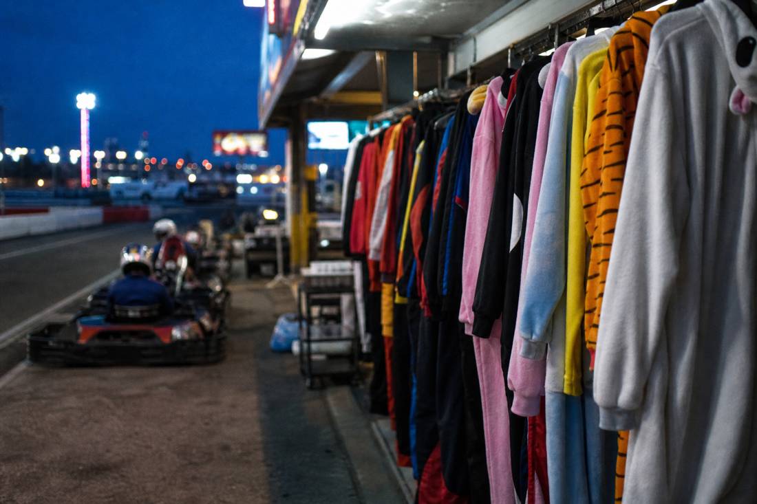 A rack of costumes in a Tokyo go-kart garage