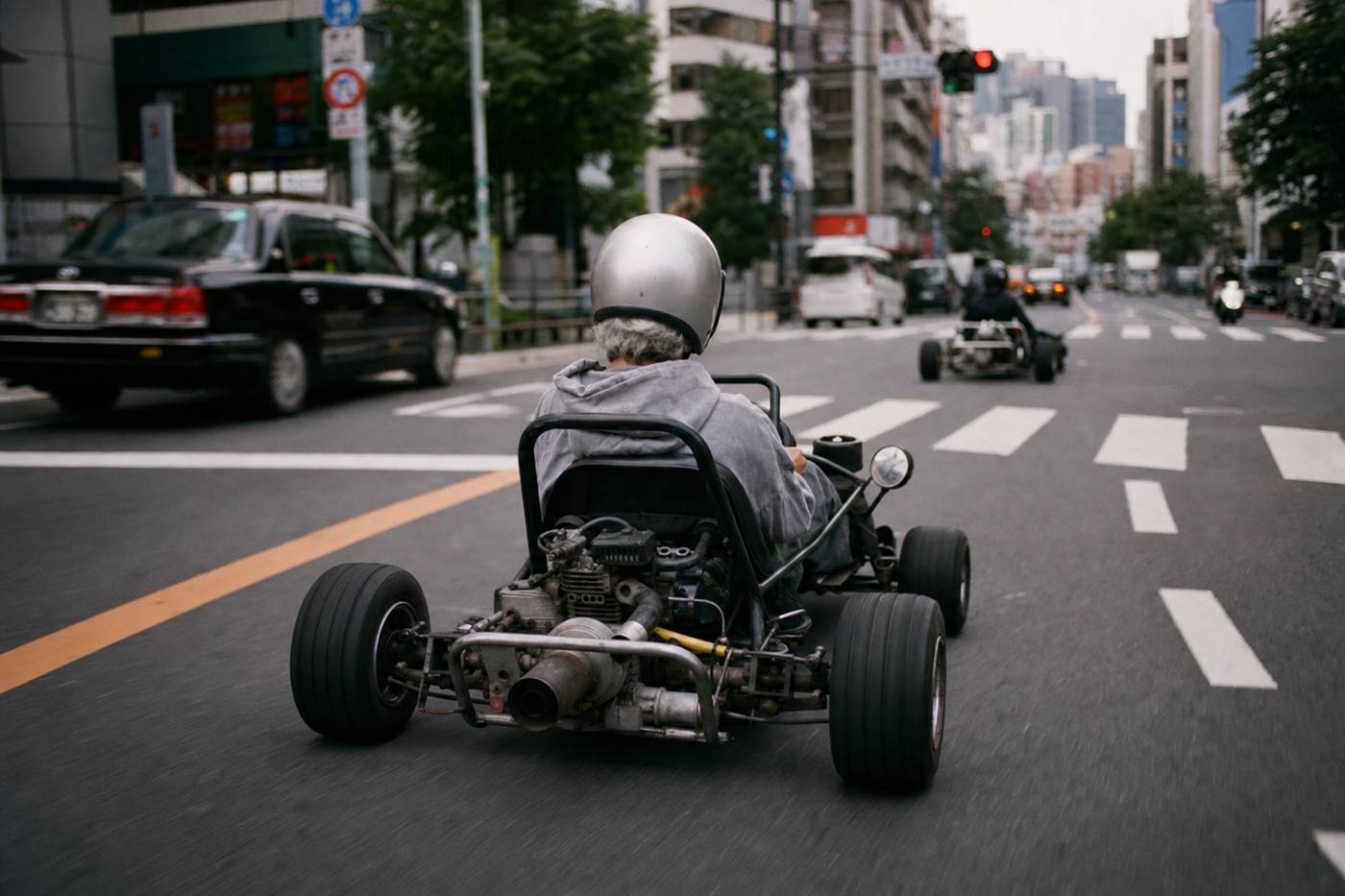 An older driver cruising a street go-kart on a calm Tokyo street