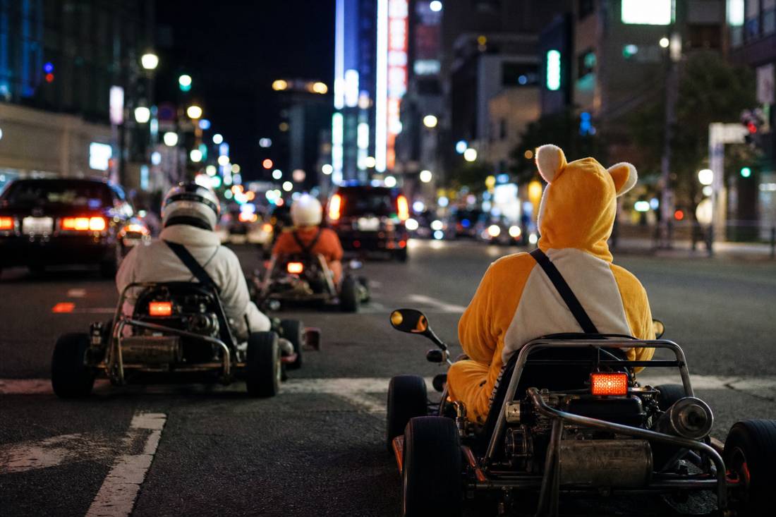 Drivers in generic costumes on Tokyo go-karts