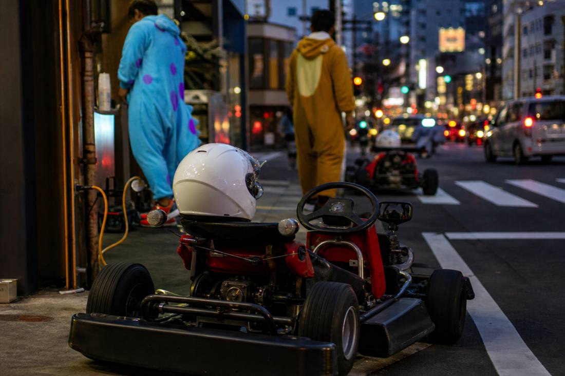 A go-kart with helmet on the seat awaiting its driver