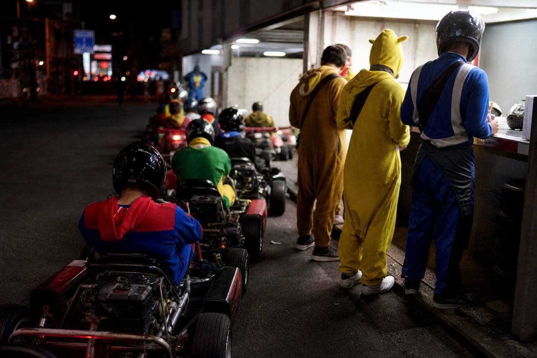 Drivers at a Tokyo go-kart garage check-in desk